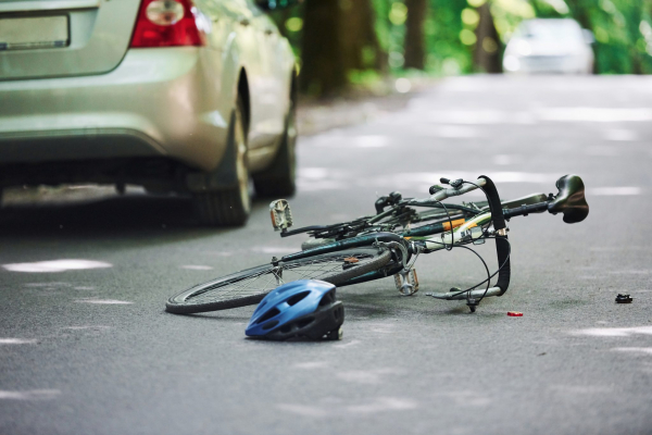 toppled bike and bike helmet on road