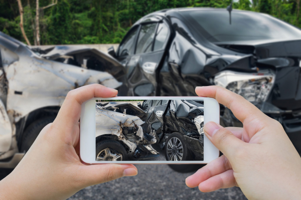 Person taking photo of car accident